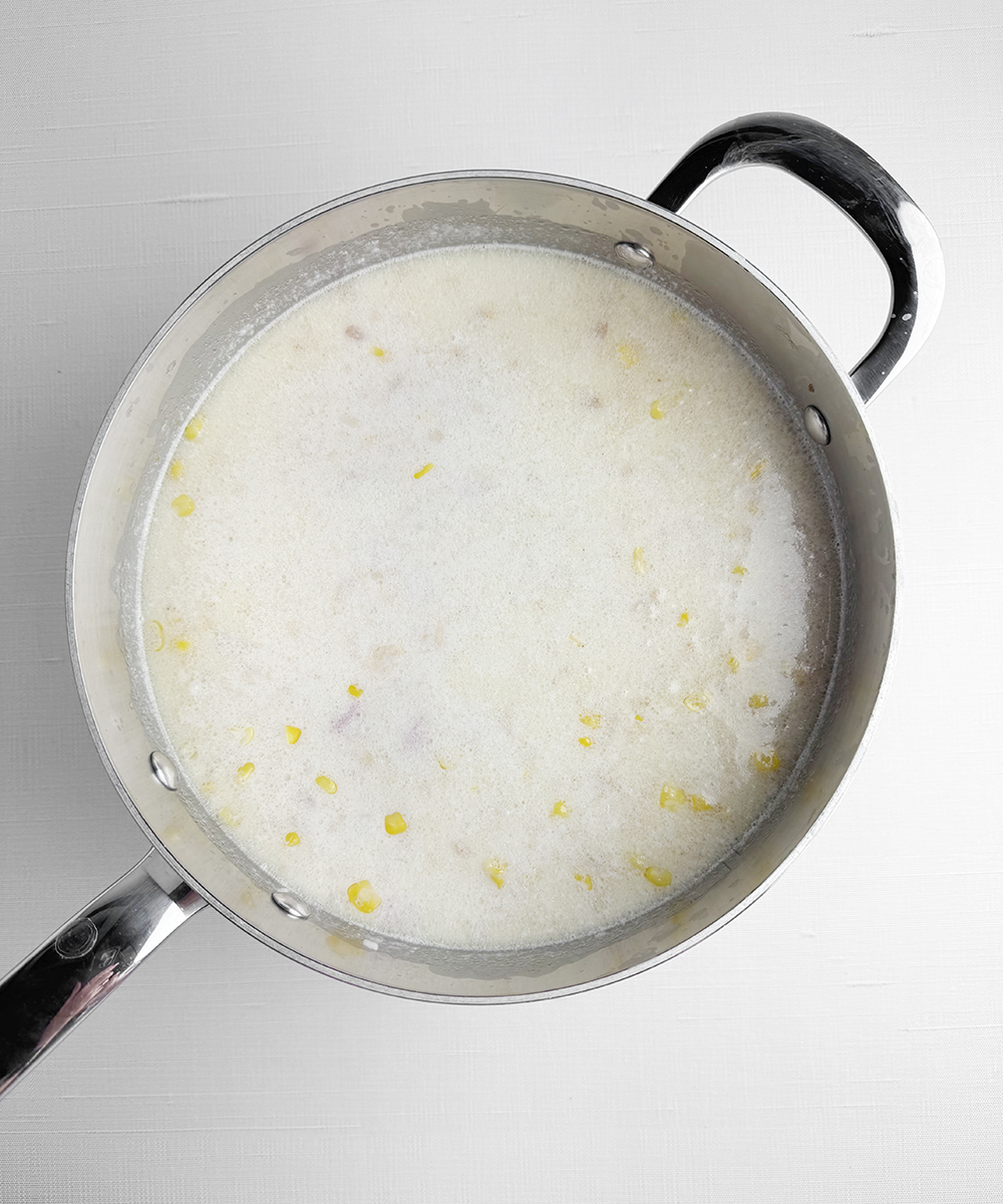 Ham and potato chowder in a pot.