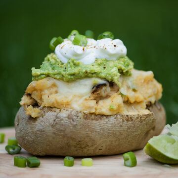 Stuffed taco potato with lime on the side.