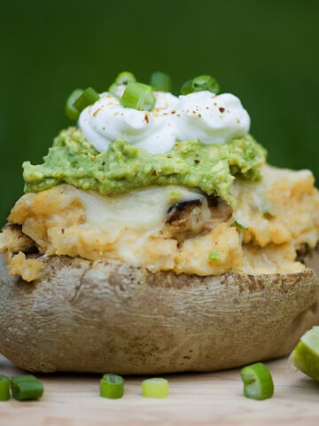 Stuffed taco potato with lime on the side.