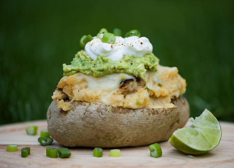 Stuffed taco potato with lime on the side.